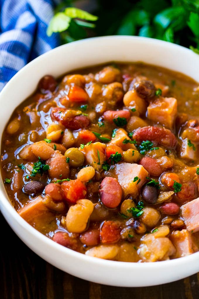Slow Cooker Ham Bone Soup | Ham and Bean Soup | Ham Bone and Bean Soup | Ham Soup | Leftover Ham Recipe #ham #hamsoup #leftoverham #soup #slowcooker #crockpot #jonep A bowl of ham bone soup with beans and vegetables.