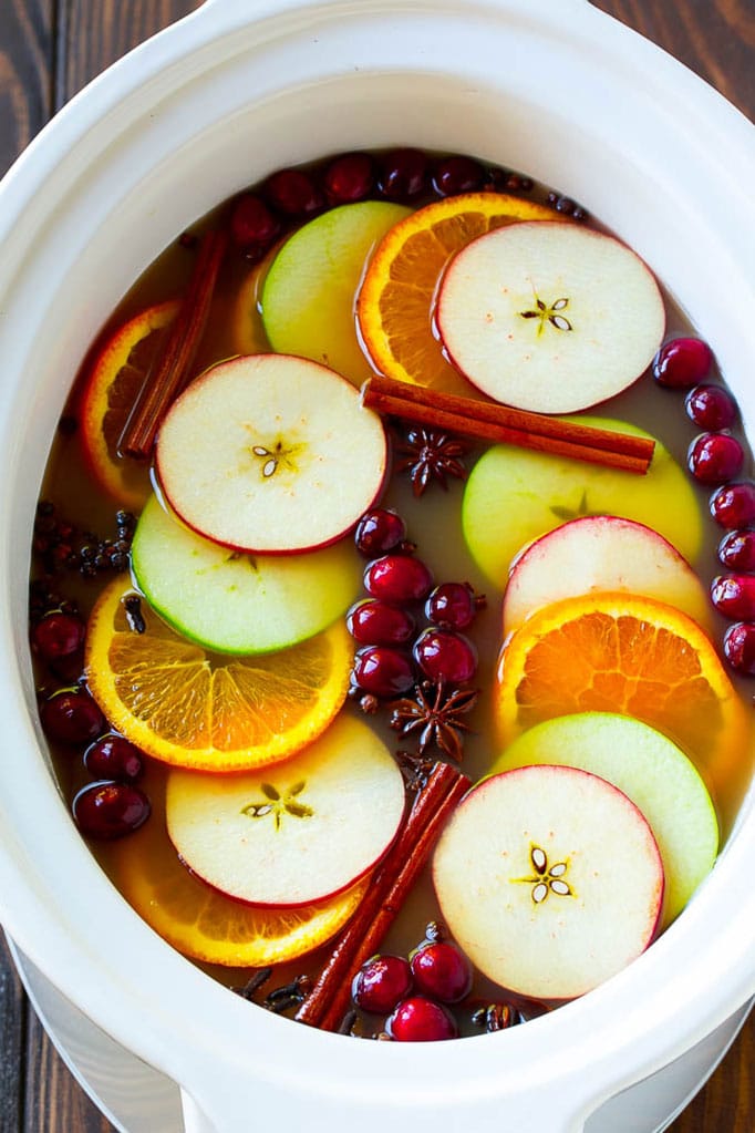 Slow Cooker Apple Cider | Mulled Apple Cider | Crockpot Apple Cider #cider #apple #applecider #drink #crockpot #slowcooker #jonep Slow cooker apple cider garnished with apple slices, oranges, cranberries, cinnamon sticks and spices.