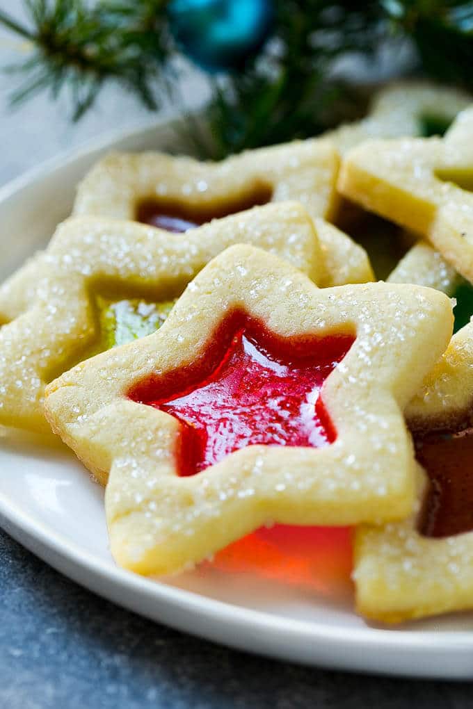Stained Glass Cookies | Stained Glass Window Cookies | Christmas Cookies | Sugar Cookies | Holiday Cookies #cookies #stainedglasscookies #sugarcookies #christmascookies #christmas #holiday #dessert #jonep A star shaped cookie on a serving plate.
