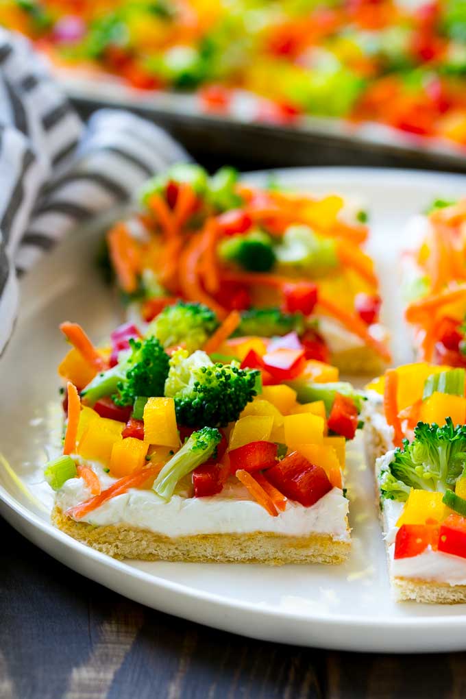 Veggie Pizza Recipe | Crescent Veggie Pizza | Vegetable Pizza Recipe | Holiday Appetizer | Homemade Veggie Pizza #pizza #veggies #vegetarian #appetizer #jonep Slices of veggie pizza on a serving plate.