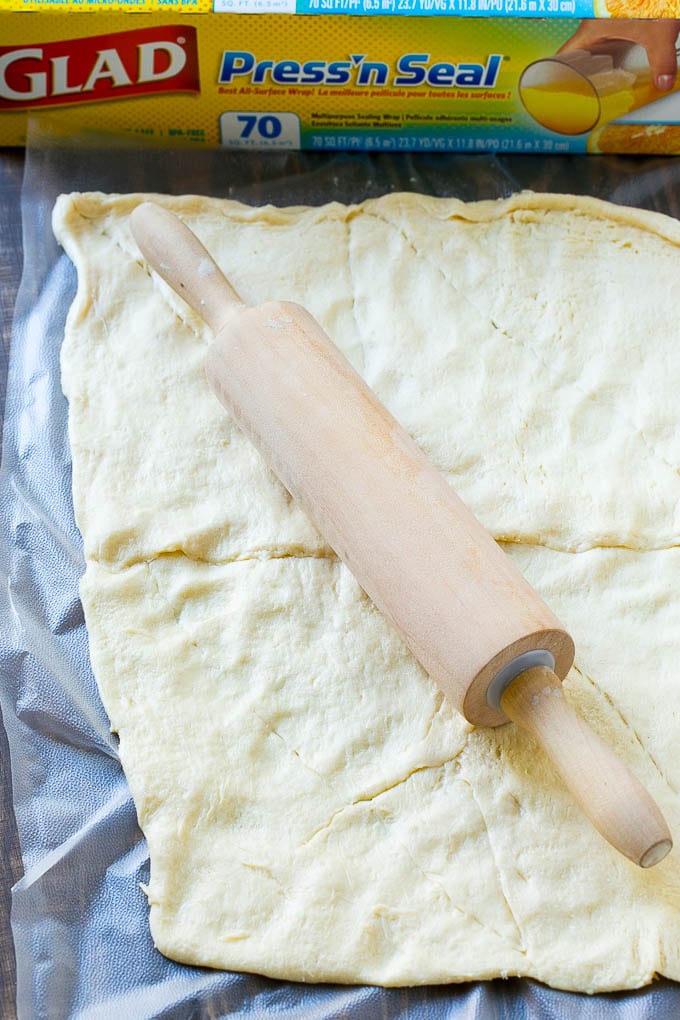 Veggie Pizza Recipe | Crescent Veggie Pizza | Vegetable Pizza Recipe | Holiday Appetizer | Homemade Veggie Pizza #pizza #veggies #vegetarian #appetizer #jonep Crescent roll dough rolled out into a rectangle.