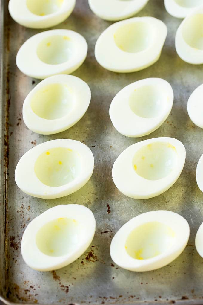 Bacon Deviled Eggs | Deviled Eggs Recipe #eggs #keto #lowcarb #bacon #appetizer #jonep Egg white halves on a sheet pan.
