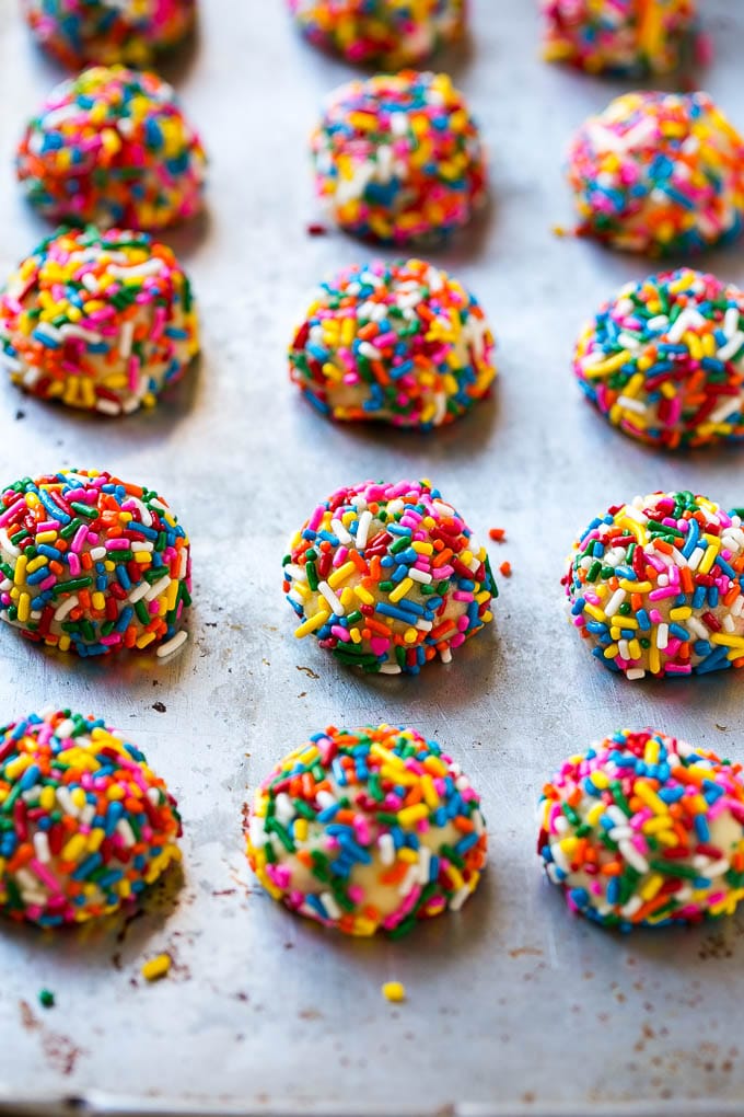 Funfetti Cookies Recipe | Funfetti Cake Mix Cookies | Sprinkle Cookies | Cake Mix Cookies #cookies #funfetti #sprinkles #dessert #jonep Balls of cookie dough coated in sprinkles.