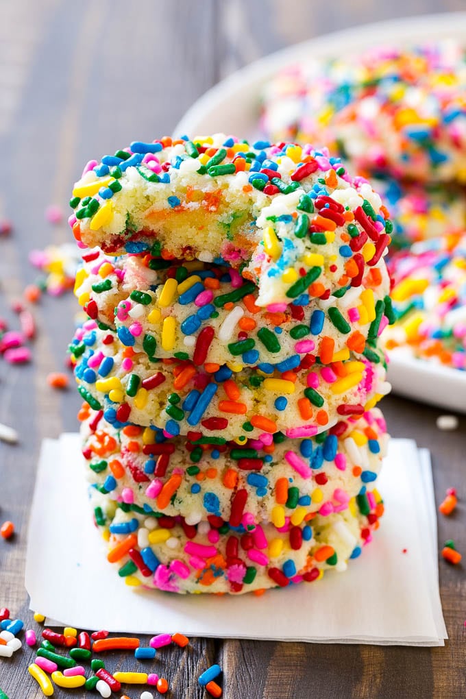 Funfetti Cookies Recipe | Funfetti Cake Mix Cookies | Sprinkle Cookies | Cake Mix Cookies #cookies #funfetti #sprinkles #dessert #jonep A stack of funfetti cookies with a bite taken out of one.