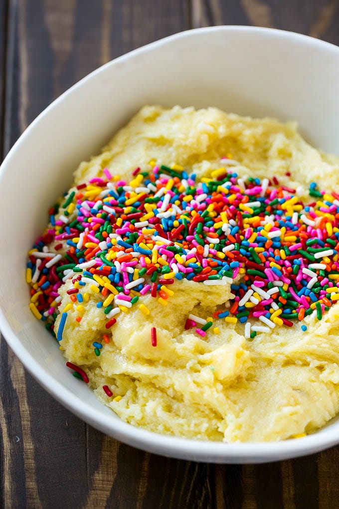Funfetti Cookies Recipe | Funfetti Cake Mix Cookies | Sprinkle Cookies | Cake Mix Cookies #cookies #funfetti #sprinkles #dessert #jonep Cookie dough in a bowl with sprinkles on top.