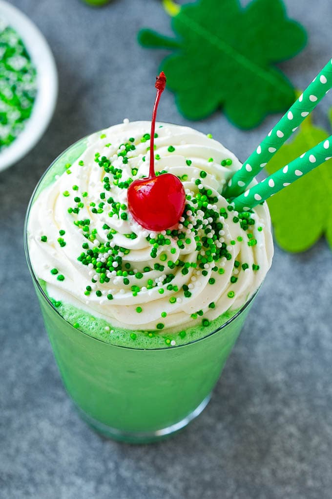 Shamrock Shake Recipe | McDonald's Shamrock Shake | Saint Patrick's Day Drink | Mint Milkshake #milkshake #stpatricksday #saintpatricksday #mint #jonep A mint Shamrock shake finished off with a swirl of whipped cream sprinkles and a cherry.