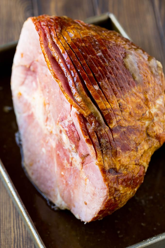 Coca Cola Ham | Coke Glazed Ham | Easter Ham | Christmas Ham | Holiday Ham Recipe #ham #easter #christmas #dinner #jonep An uncooked spiral ham topped with coke and brown sugar.