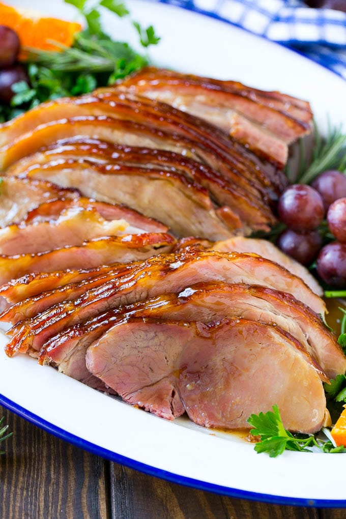 Coca Cola Ham | Coke Glazed Ham | Easter Ham | Christmas Ham | Holiday Ham Recipe #ham #easter #christmas #dinner #jonep A platter of sliced coca cola ham with herbs.