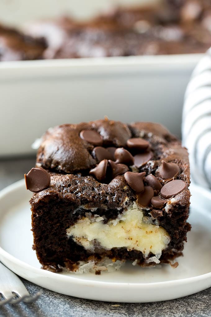 Earthquake Cake Recipe | Chocolate Cake Recipe | Chocolate Coconut Cake | Coconut Pecan Cake #cake #chocolate #coconut #pecans #dessert #chocolatecake #jonep A slice of earthquake cake on a plate.