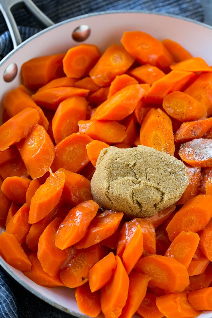 Candied Carrots Recipe | Carrot Side Dish | Brown Sugar Carrots | Glazed Carrots #carrots #brownsugar #sidedish #dinner #jonep Sliced carrots with butter, brown sugar and seasonings in a pan.