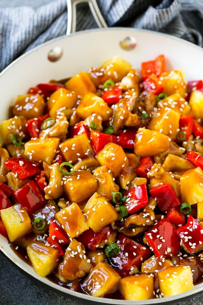 Pineapple Chicken | Hawaiian Chicken | Chicken Stir Fry #pineapple #chicken #dinner #stirfry #jonep Pineapple chicken stir fry in a skillet, topped with sauce, sesame seeds and green onions.