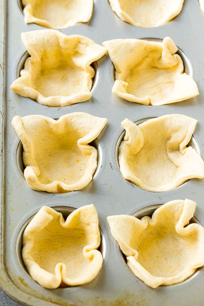 Pizza Muffins Recipe | Pizza Bites | Pizza Cups | Pizza Appetizer #pizza #appetizer #jonep Crescent roll dough pressed into a tin forms the crust.