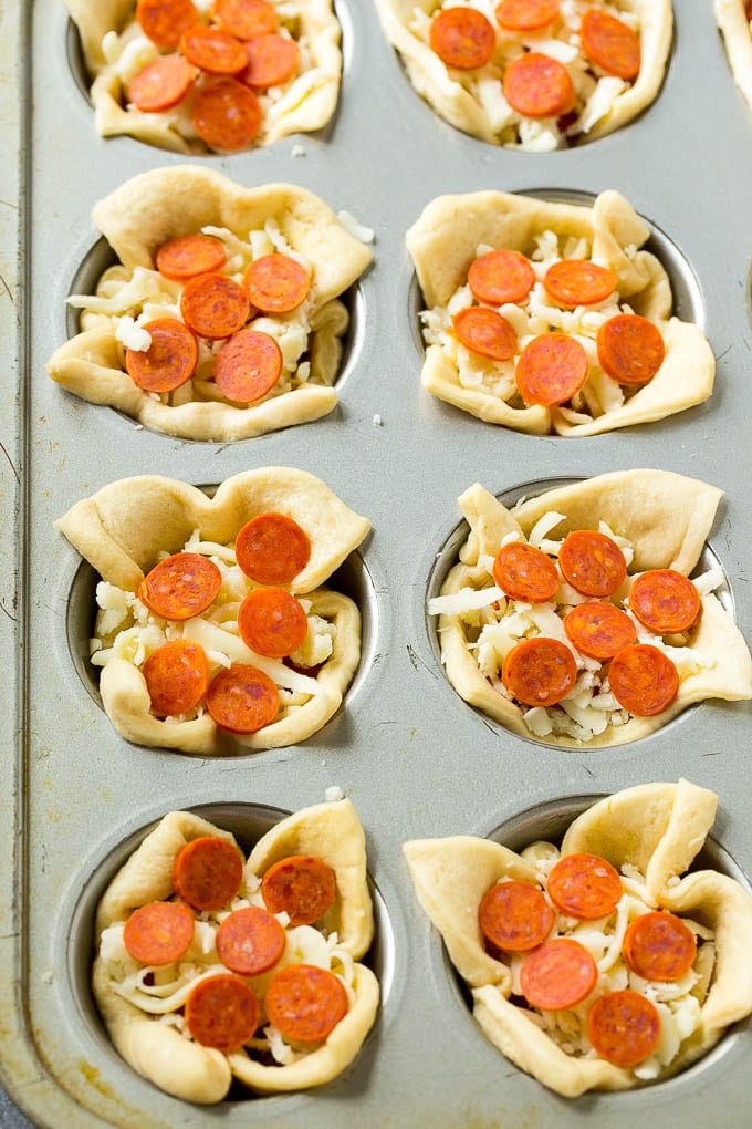 Pizza Muffins Recipe | Pizza Bites | Pizza Cups | Pizza Appetizer #pizza #appetizer #jonep Unbaked dough cups filled with cheese, sauce and pepperoni.