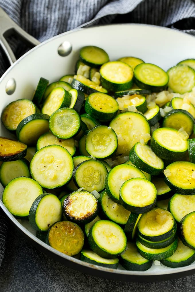 Zucchini Gratin Recipe | Cheesy Zucchini | Baked Zucchini | Easy Zucchini Recipe #zucchini #casserole #cheese #dinner #sidedish #jonep Sauteed zucchini and onions in a skillet.