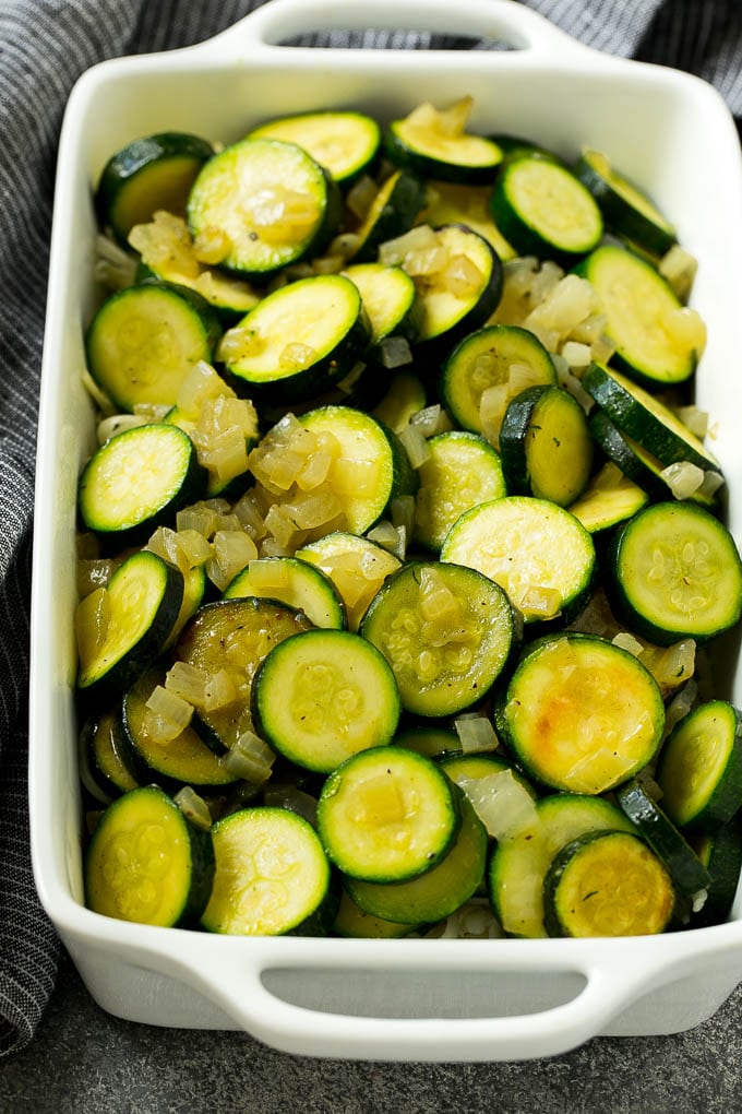 Zucchini Gratin Recipe | Cheesy Zucchini | Baked Zucchini | Easy Zucchini Recipe #zucchini #casserole #cheese #dinner #sidedish #jonep Sauteed zucchini and onions in a baking dish.
