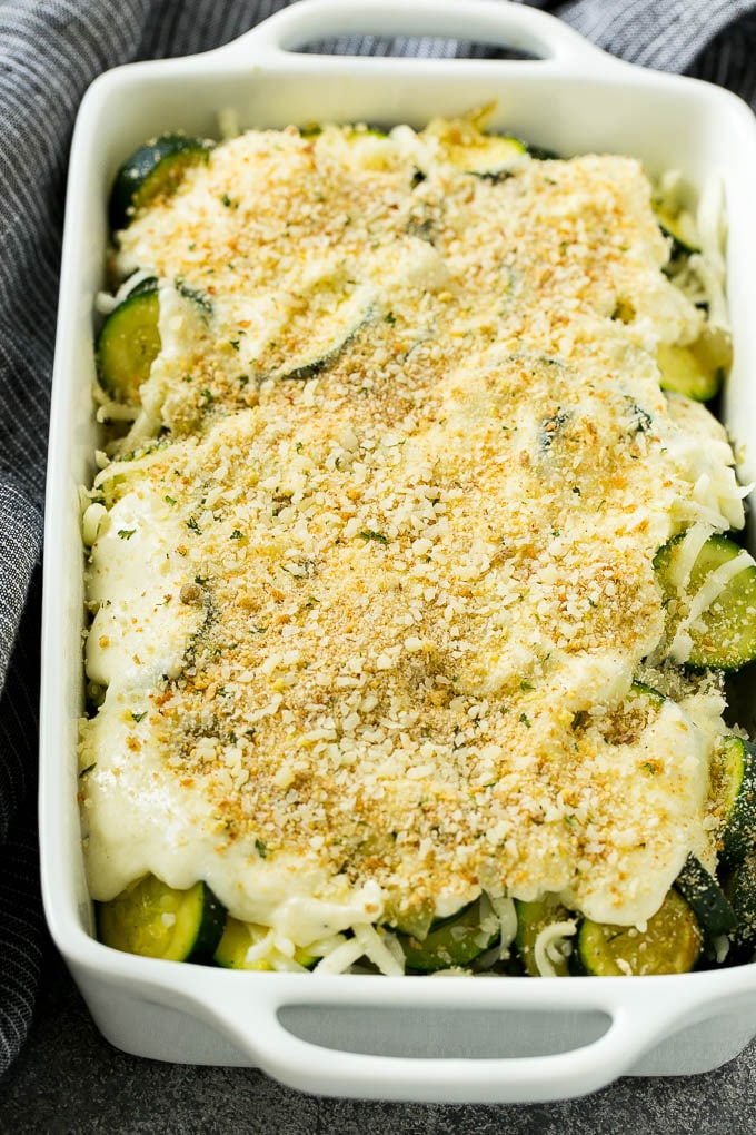 Zucchini Gratin Recipe | Cheesy Zucchini | Baked Zucchini | Easy Zucchini Recipe #zucchini #casserole #cheese #dinner #sidedish #jonep Zucchini gratin with layers of cheese, sauce and breadcrumbs, ready to go into the oven.