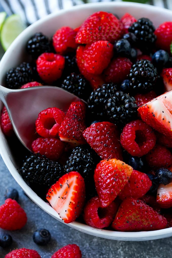 Berry Fruit Salad Recipe | Berry Salad | Summer Berry Salad | Fruit Salad Recipe #berries #fruitsalad #jonep A bowl of berry fruit salad with a serving spoon in it.