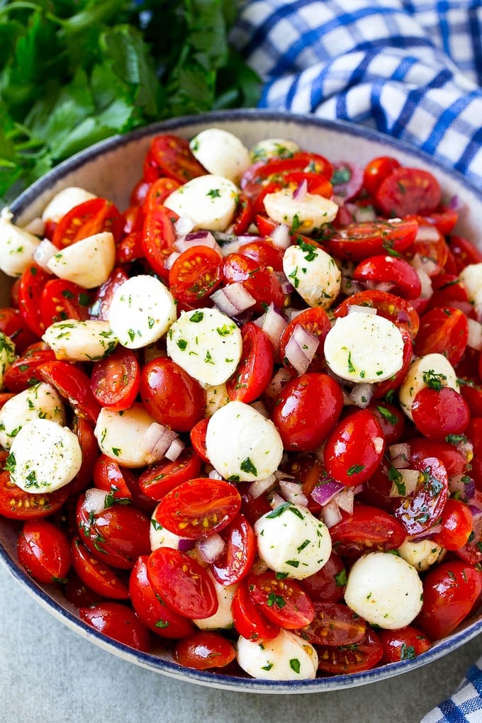 Cherry Tomato Salad Recipe | Tomato Mozzarella Salad | Caprese Salad | Tomato Salad #tomatoes #salad #tomatosalad #caprese #jonep A serving bowl of tomato mozzarella salad with cherry tomatoes, herbs and red onion.