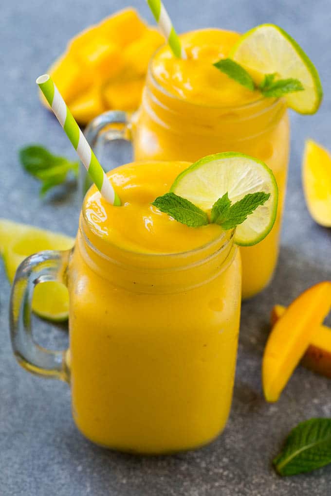 Mango Smoothie Recipe | Mango Recipe | Healthy Smoothie #mango #smoothie #drink #jonep Mango smoothie in a mug topped with a slice of lime and mint sprig.