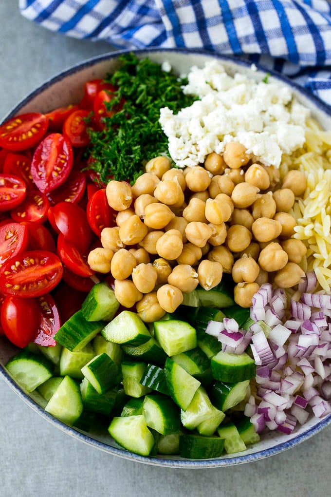 Orzo Salad Recipe | Orzo Pasta Salad | Greek Orzo Salad | Mediterranean Orzo Salad #pastasalad #orzo #greekfood #salad #jonep A bowl of orzo pasta, cucumbers, cherry tomatoes, feta cheese, red onions, herbs and chickpeas.