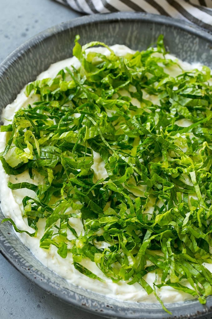 BLT Dip Recipe | Bacon Dip Recipe | Ranch Dip #dip #ranch #bacon #lettuce #tomato #appetizer #jonep Shredded romaine lettuce over a sour cream, cream cheese and ranch powder base.