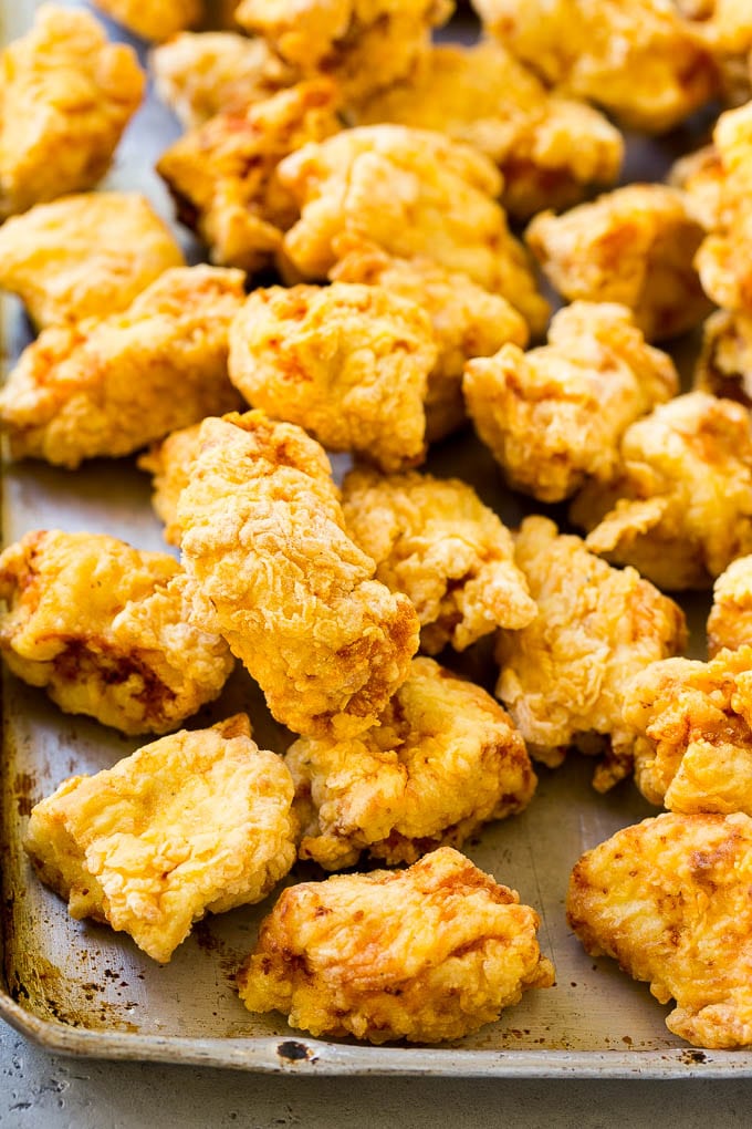 Sweet and Sour Chicken Recipe | Chinese Food Copycat Recipe | Chicken with Pineapple #chicken #chinesefood #pineapple #stirfry #takeout #dinner #jonep Fried pieces of chicken thighs on a sheet pan.
