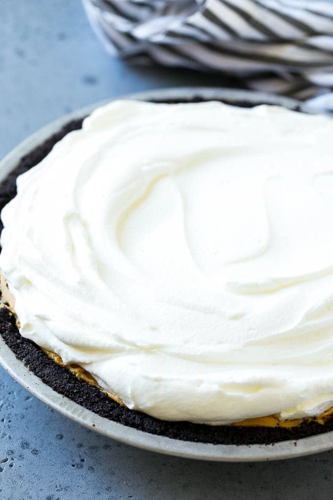 Chocolate Peanut Butter Pie Recipe | Peanut Butter Cup Pie | Peanut Butter Pie | No Bake Pie #chocolate #peanutbutter #pie #nobake #dessert #jonep Whipped cream topping on top of a nut butter tart.