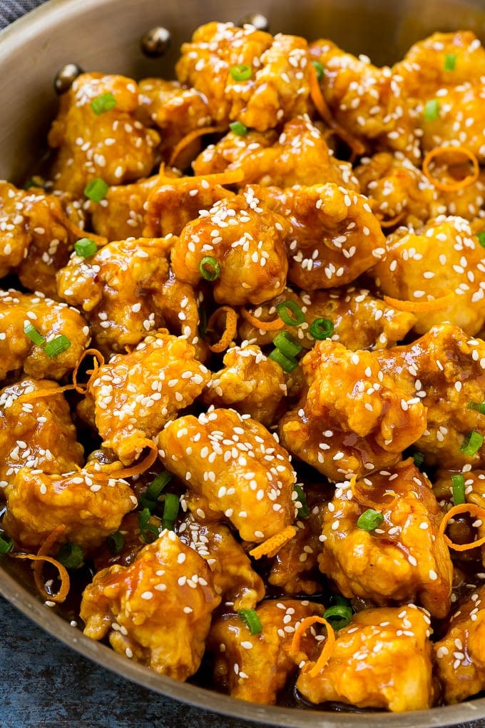 Orange Chicken Recipe | Chinese Orange Chicken | Panda Express Orange Chicken #orange #chicken #takeout #chinesefood #dinner #jonep Orange chicken in a skillet with crispy chicken, sesame seeds, orange zest and green onions.