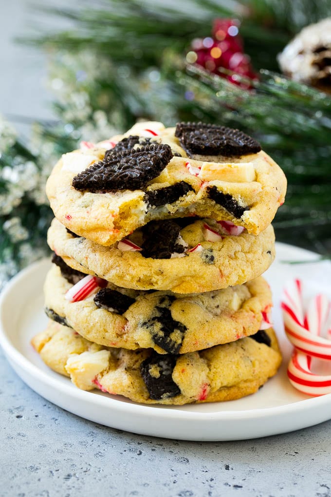 Oreo Peppermint Cookies Recipe | Candy Cane Cookies | Oreo Cookies #oreo #peppermint #cookies #baking #Christmas #sweets #jonep A stack of Oreo peppermint cookies on a plate, garnished with candy canes.