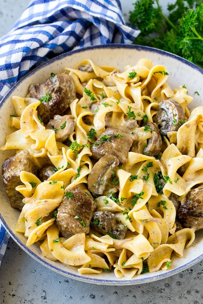 Slow Cooker Beef Stroganoff Recipe | Crock Pot Beef Stroganoff | Beef Recipe #slowcooker #crockpot #beef #mushrooms #pasta #dinner #jonep A bowl of slow cooker beef stroganoff with egg noodles.