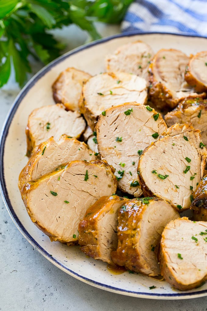 Slow Cooker Pork Tenderloin Recipe | Crock Pot Pork Tenderloin | Easy Pork Tenderloin #slowcooker #crockpot #pork #dinner #jonep Sliced slow cooker pork tenderloin on a plate.