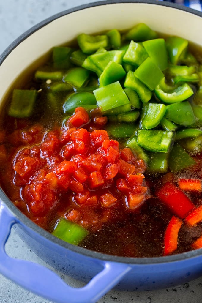 Stuffed Pepper Soup Recipe | Beef and Rice Soup | Stuffed Peppers #peppers #soup #beef #rice #dinner #jonep Ground beef, tomatoes, peppers and beef broth in a pot.