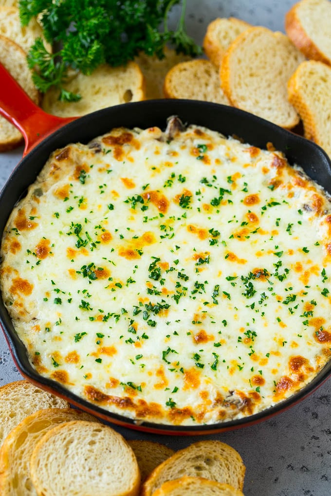 Philly Cheesesteak Dip Recipe | Cheesy Dip | Baked Cheese Dip #steak #dip #appetizer #cheese #jonep A skillet of baked Philly cheesesteak dip with melted cheese and parsley on top.