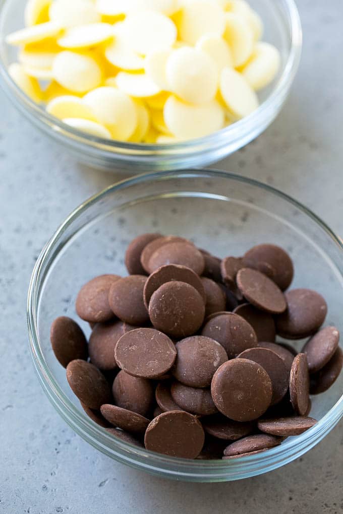 Chocolate Covered Oreos Recipe | Oreo Cookies | Chocolate Dipped Oreos #oreo #cookies #chocolate #sprinkles #dessert #jonep Dark chocolate candy melts and white chocolate candy melts in bowls.