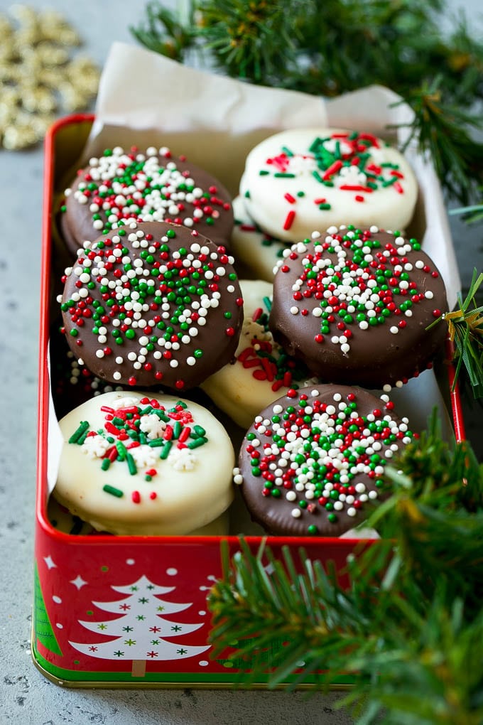 Chocolate Covered Oreos Recipe | Oreo Cookies | Chocolate Dipped Oreos #oreo #cookies #chocolate #sprinkles #dessert #jonep Christmas chocolate covered Oreos in a gift tin.