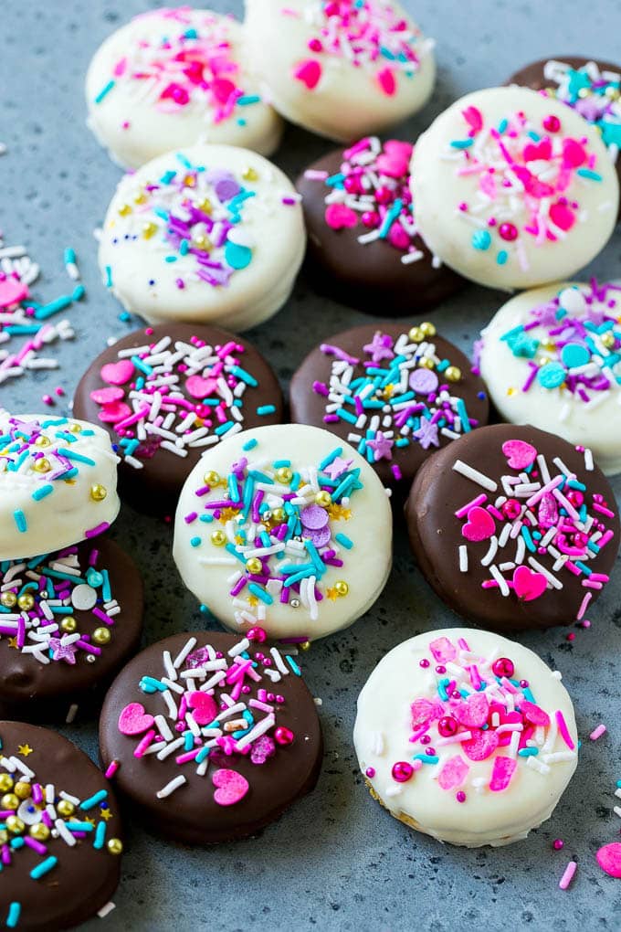 Chocolate Covered Oreos Recipe | Oreo Cookies | Chocolate Dipped Oreos #oreo #cookies #chocolate #sprinkles #dessert #jonep Chocolate covered Oreos decorated with pink and purple sprinkles.