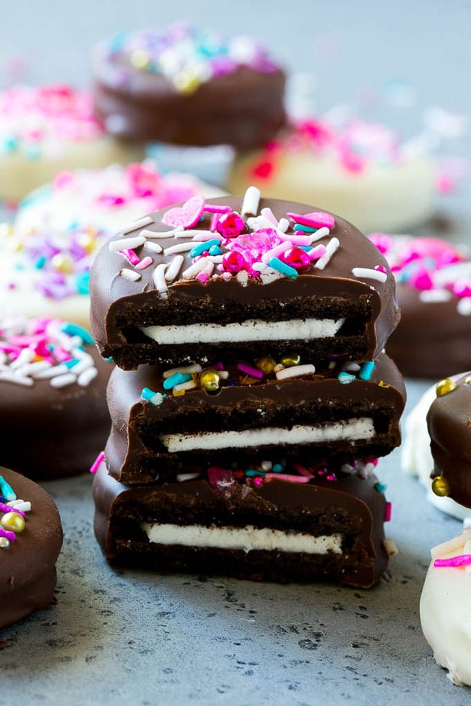 Chocolate Covered Oreos Recipe | Oreo Cookies | Chocolate Dipped Oreos #oreo #cookies #chocolate #sprinkles #dessert #jonep Three chocolate covered Oreos stacked on top of each other.
