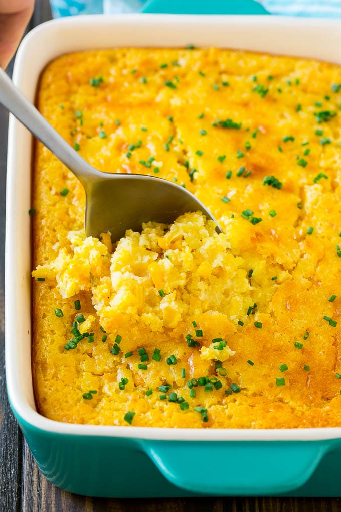 Corn Pudding Recipe | Corn Casserole | Corn Side Dish #corn #pudding #casserole #sidedish #thanksgiving #dinner #jonep A pan of corn pudding with a serving spoon in it.