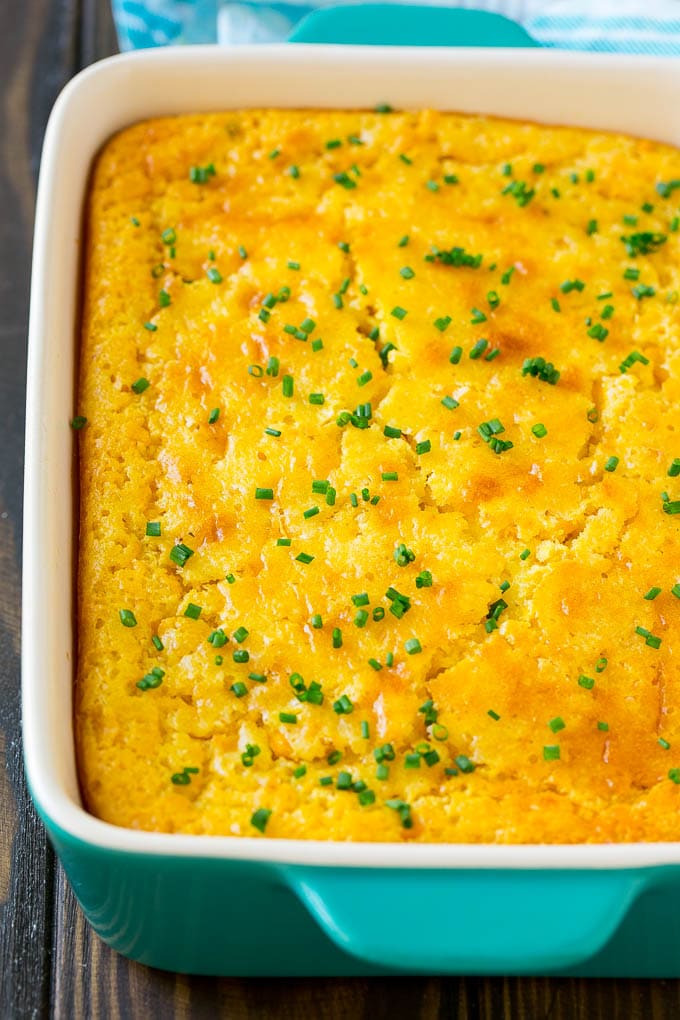 Corn Pudding Recipe | Corn Casserole | Corn Side Dish #corn #pudding #casserole #sidedish #thanksgiving #dinner #jonep A casserole dish of corn pudding topped with chives.