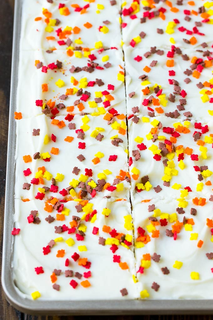 Pumpkin Bars Recipe | Pumpkin Cake | Pumpkin Dessert #pumpkin #fall #dessert #jonep #thanksgiving Cream cheese frosting and sprinkles spread over cake.