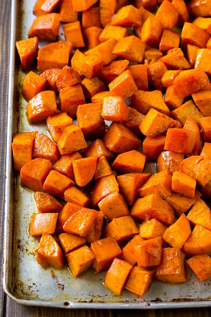 Maple Roasted Sweet Potatoes Recipe | Easy Sweet Potatoes | Baked Sweet Potatoes | Sweet Potato Side Dish #sweetpotatoes #cinnamon #maple #butter #fall #sidedish #dinner #jonep A sheet pan of roasted sweet potatoes.