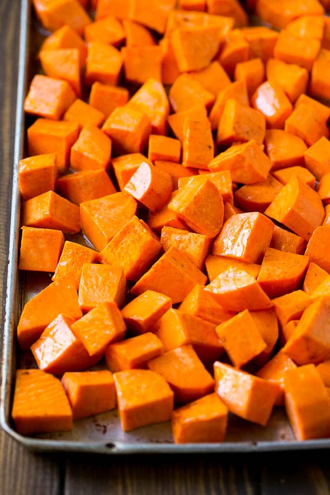 Maple Roasted Sweet Potatoes Recipe | Easy Sweet Potatoes | Baked Sweet Potatoes | Sweet Potato Side Dish #sweetpotatoes #cinnamon #maple #butter #fall #sidedish #dinner #jonep Raw diced sweet potatoes on a sheet pan, ready to go into the oven.