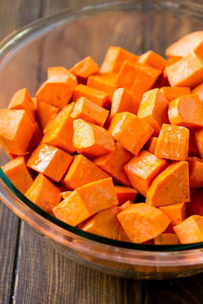 Maple Roasted Sweet Potatoes Recipe | Easy Sweet Potatoes | Baked Sweet Potatoes | Sweet Potato Side Dish #sweetpotatoes #cinnamon #maple #butter #fall #sidedish #dinner #jonep A bowl of peeled and diced yams.