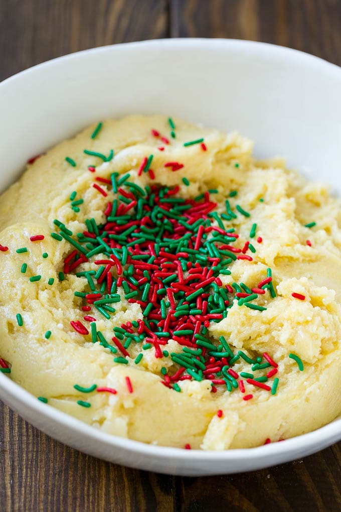 Cake Mix Cookies Recipe | Sprinkle Cookies | Christmas Cookies #cookies #christmas #sprinkles #dessert #baking #jonep A bowl of dough with sprinkles on top.