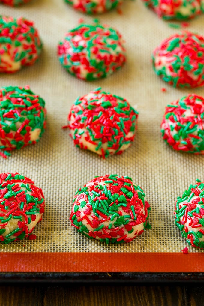 Cake Mix Cookies Recipe | Sprinkle Cookies | Christmas Cookies #cookies #christmas #sprinkles #dessert #baking #jonep Balls of dough rolled in sprinkles.