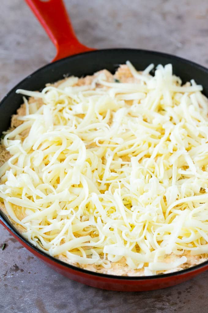 Crab Dip Recipe | Hot Crab Dip | Seafood Dip #dip #crab #seafood #appetizer #jonep #cheese Shredded Monterey Jack cheese sprinkled over a skillet of mixture.