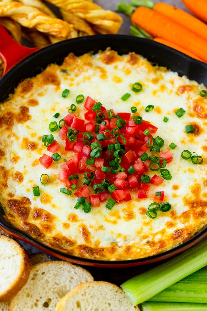 Crab Dip Recipe | Hot Crab Dip | Seafood Dip #dip #crab #seafood #appetizer #jonep #cheese Hot crab dip in a skillet topped with tomatoes and green onions.