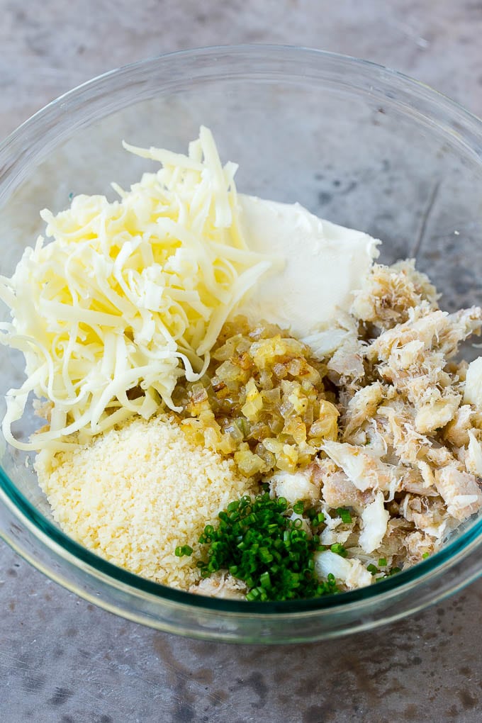 Crab Stuffed Mushrooms Recipe | Stuffed Mushrooms | Mushroom Appetizer #crab #seafood #mushrooms #lowcarb #appetizer #jonep A bowl of crab meat, cheese, chives, onions and garlic.