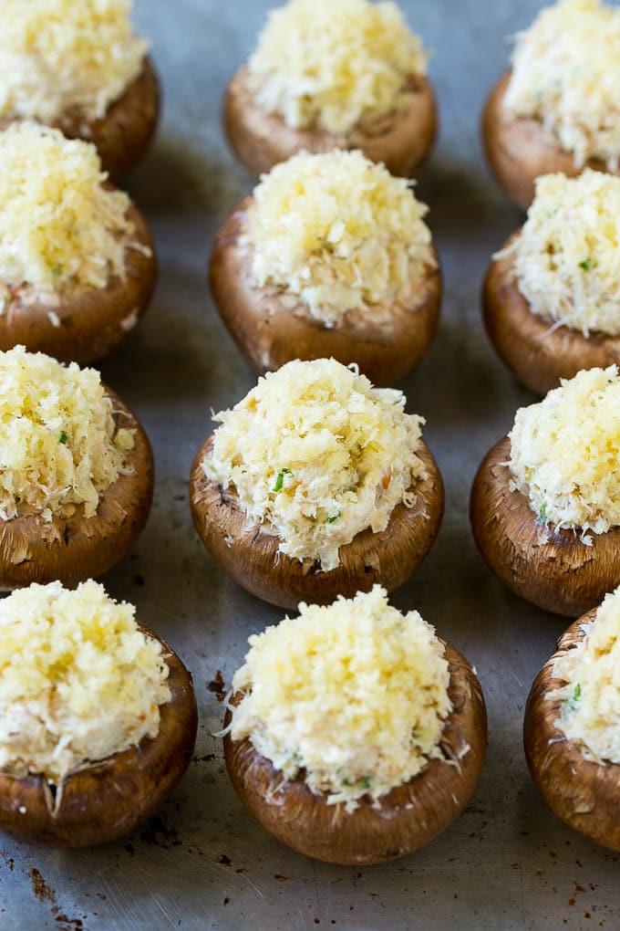 Crab Stuffed Mushrooms Recipe | Stuffed Mushrooms | Mushroom Appetizer #crab #seafood #mushrooms #lowcarb #appetizer #jonep Uncooked crab stuffed mushrooms on a sheet pan.