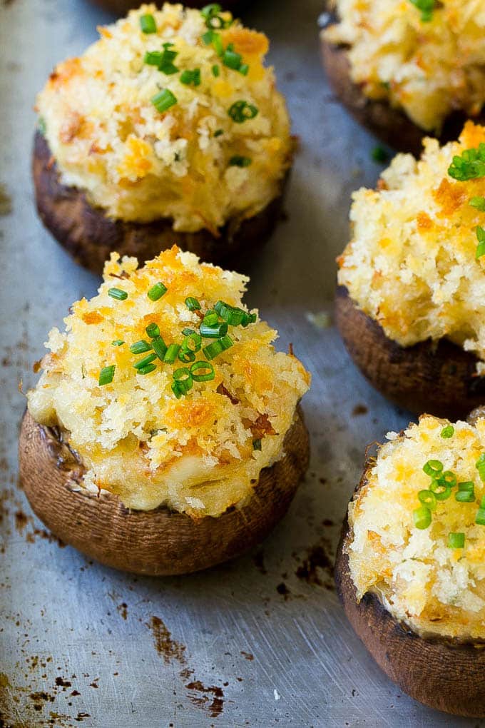 Crab Stuffed Mushrooms Recipe | Stuffed Mushrooms | Mushroom Appetizer #crab #seafood #mushrooms #lowcarb #appetizer #jonep Crab stuffed mushrooms on a sheet pan topped with sliced chives.